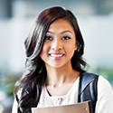 A female student holding books in class