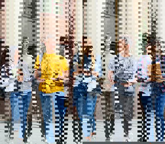 College students standing outside of a school building