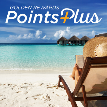 Woman in straw hat sitting on a beach chair by the ocean.